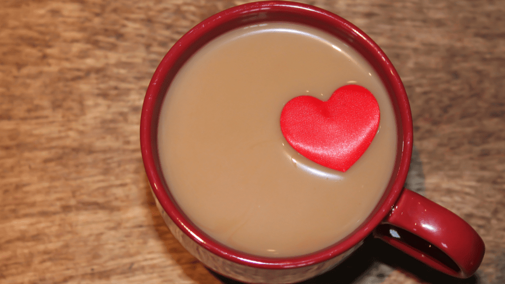 coffee mug filled with coffee and a small toy heart floating in the coffee, Caffeine, Caffeine toxicity in pets, Caffeine sources, Animal Emergency & Referral Center of Minnesota