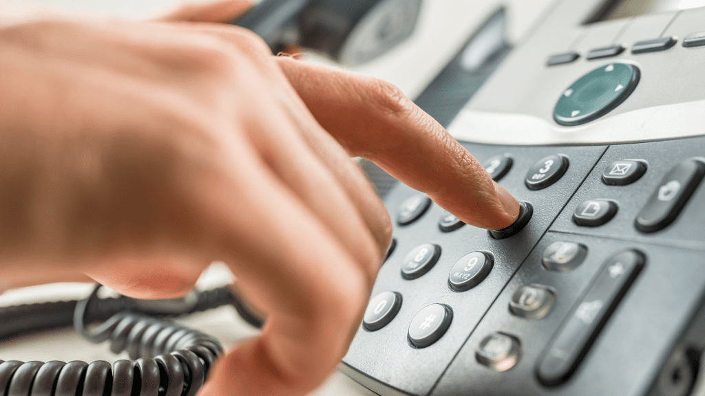 A hand dialing a phone number on a phone, toxicology hotline, Animal Emergency & Referral Center of Minnesota